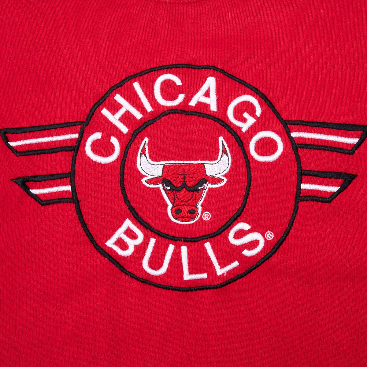 Close-up of embroidered Chicago Bulls bull-head logo with white lettering and striped wings