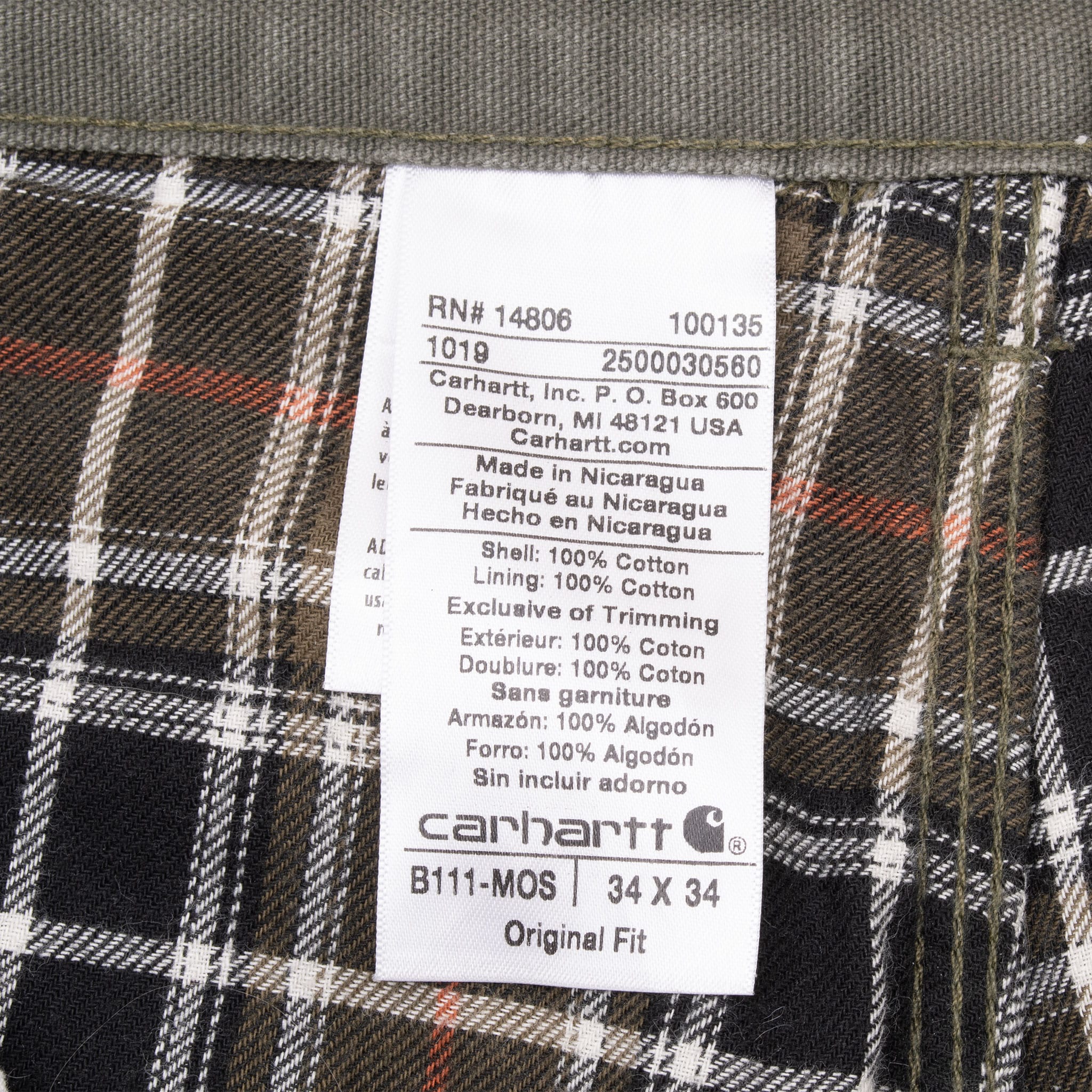 Carhartt B111-MOS garment label showing 34 x 34 size against plaid lining