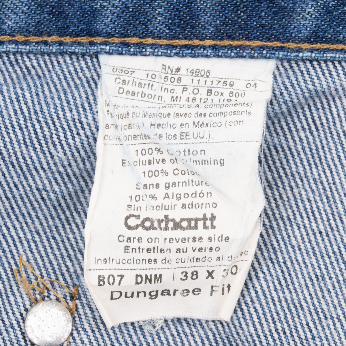 Carhartt B07 DNM dungaree fit care label showing tagged size 38 x 30