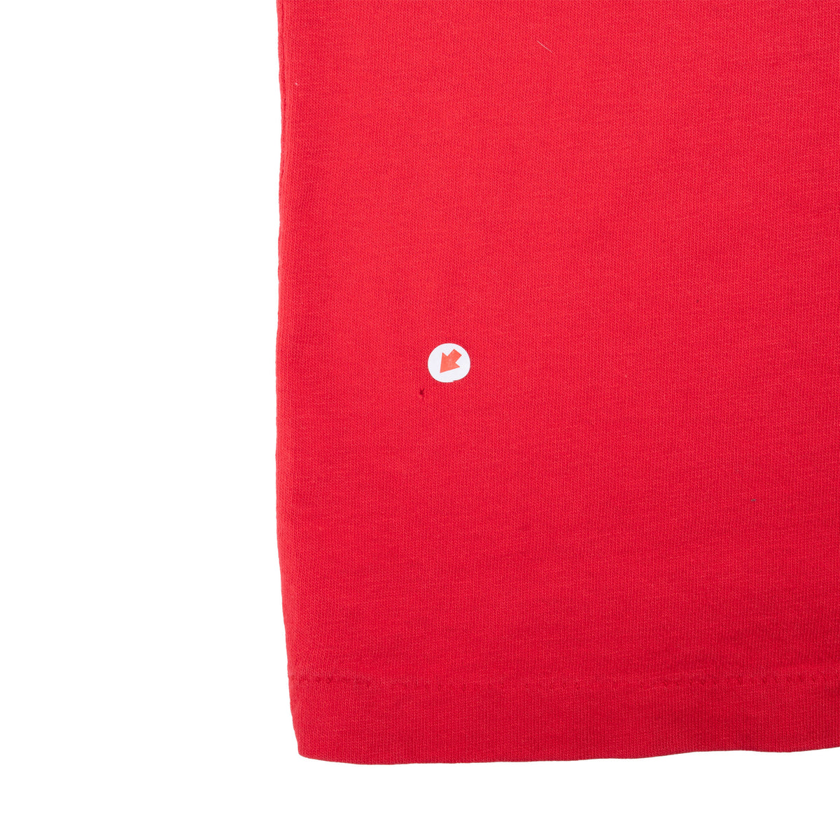 Close-up of red shirt fabric with a small spot marked near the lower edge