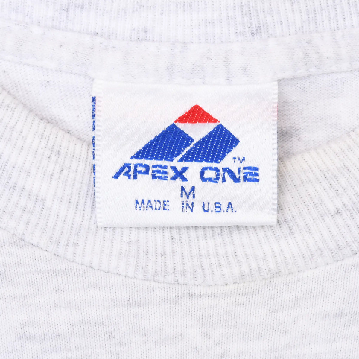 Apex One neck tag marked M and Made in U.S.A. on gray T-shirt