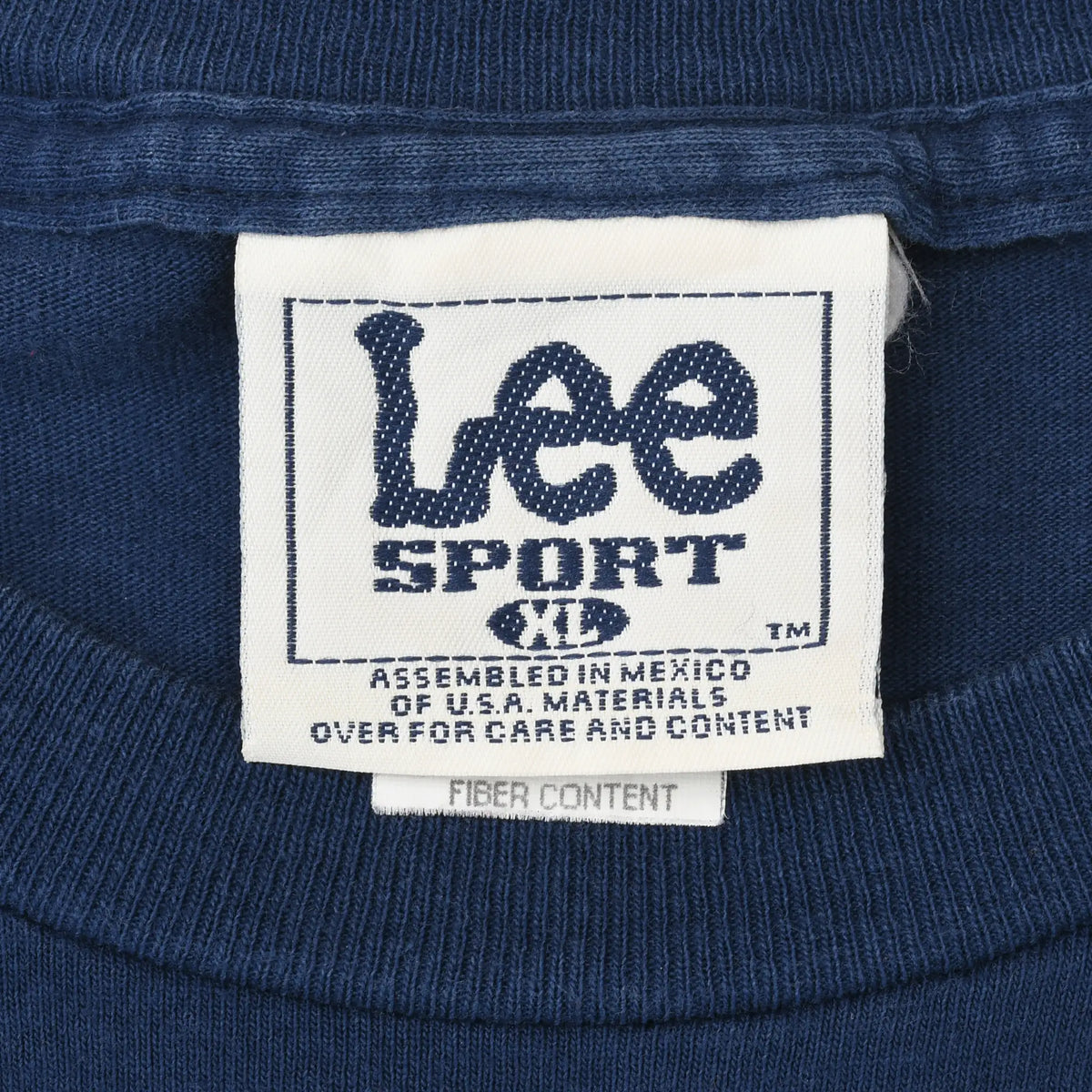 Close-up of Lee Sport XL neck tag inside navy Michigan T-shirt