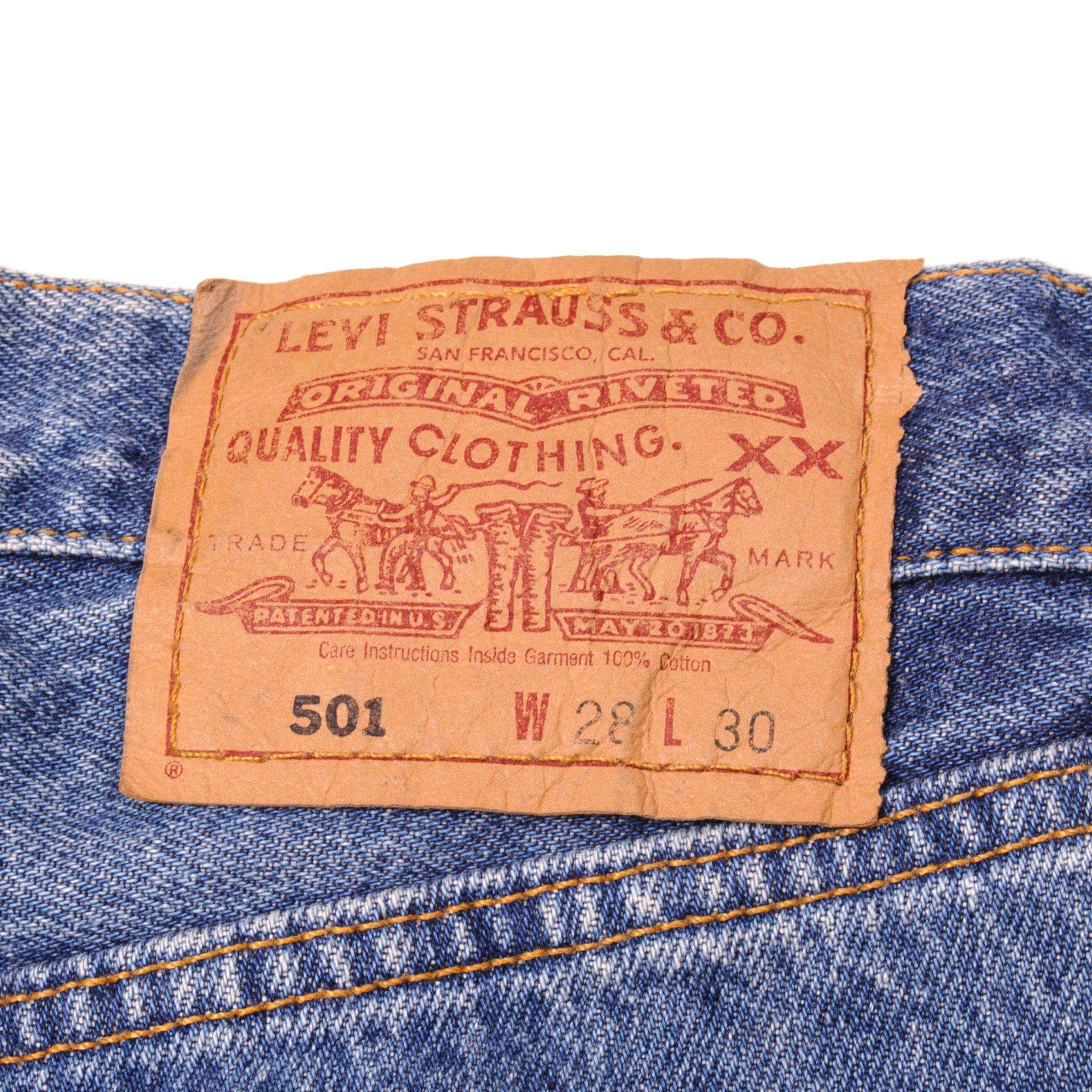 Beautiful Indigo Levis 501 Jeans Made in USA with a medium blue wash. Size on Tag 28X30 ACTUAL SIZE 28X30 Back Button #544