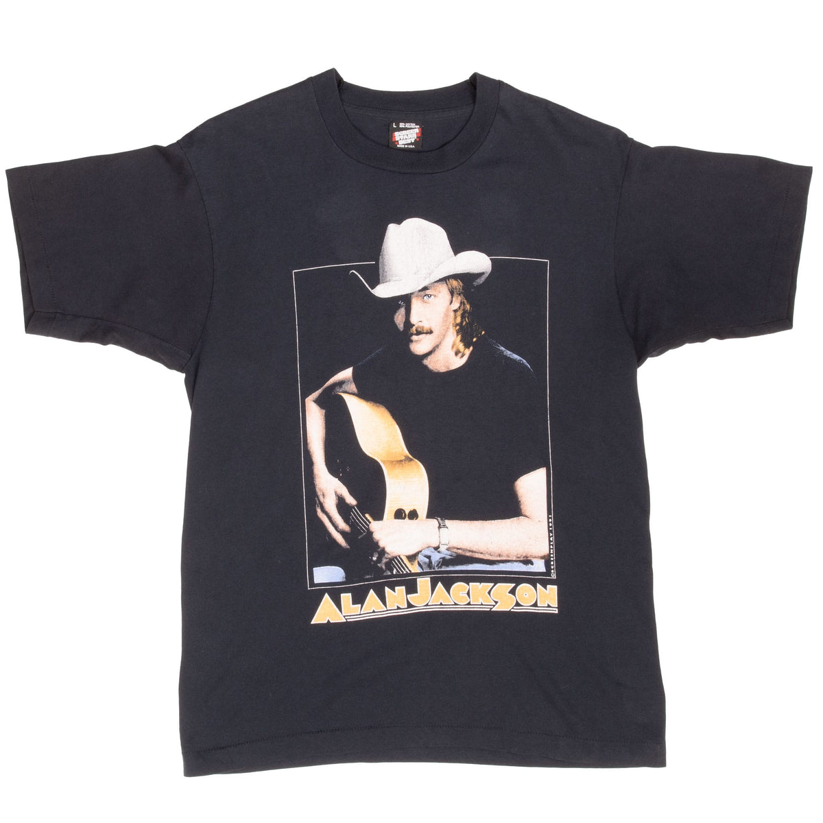 Front of black Alan Jackson T-shirt with guitar portrait and gold name lettering