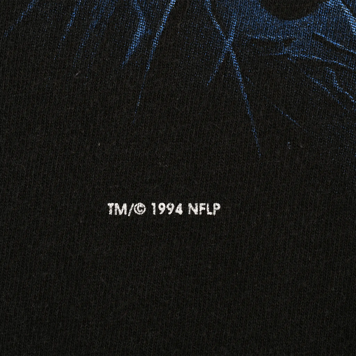 Close-up of TM and 1994 NFL copyright print on black fabric