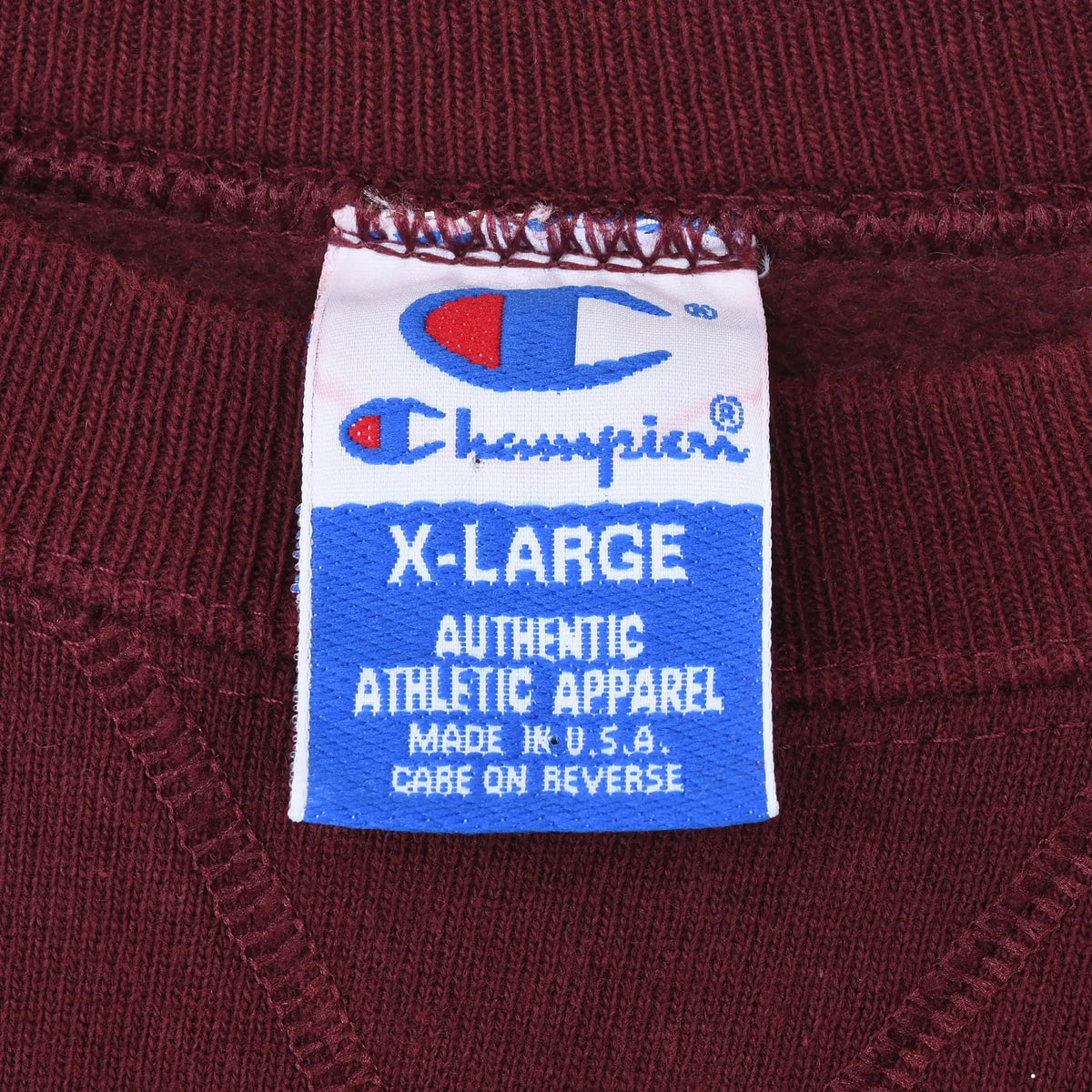 Champion X-Large neck tag on burgundy sweatshirt, marked Made in U.S.A.