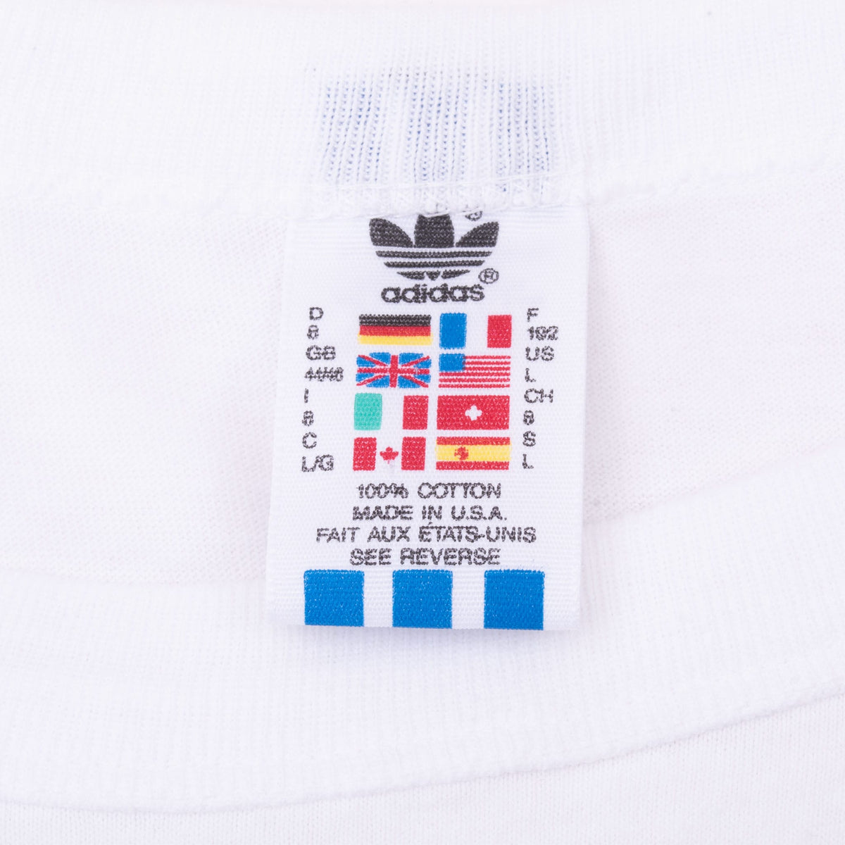 Close-up of adidas neck tag with international sizing and Made in USA text