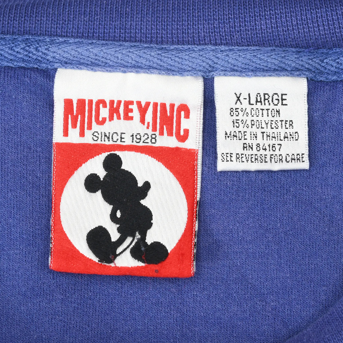 Mickey Inc neck label and X-Large care tag inside purple Disney sweatshirt