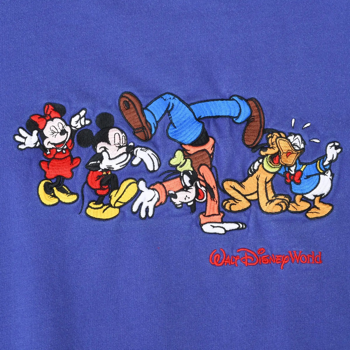 Close-up of embroidered Minnie, Mickey, Goofy, Pluto and Donald Duck Walt Disney World graphic