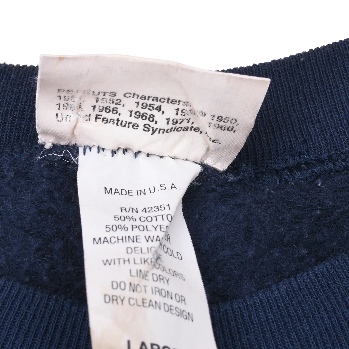 Close-up of Peanuts copyright and care labels marked Made in U.S.A. inside sweatshirt