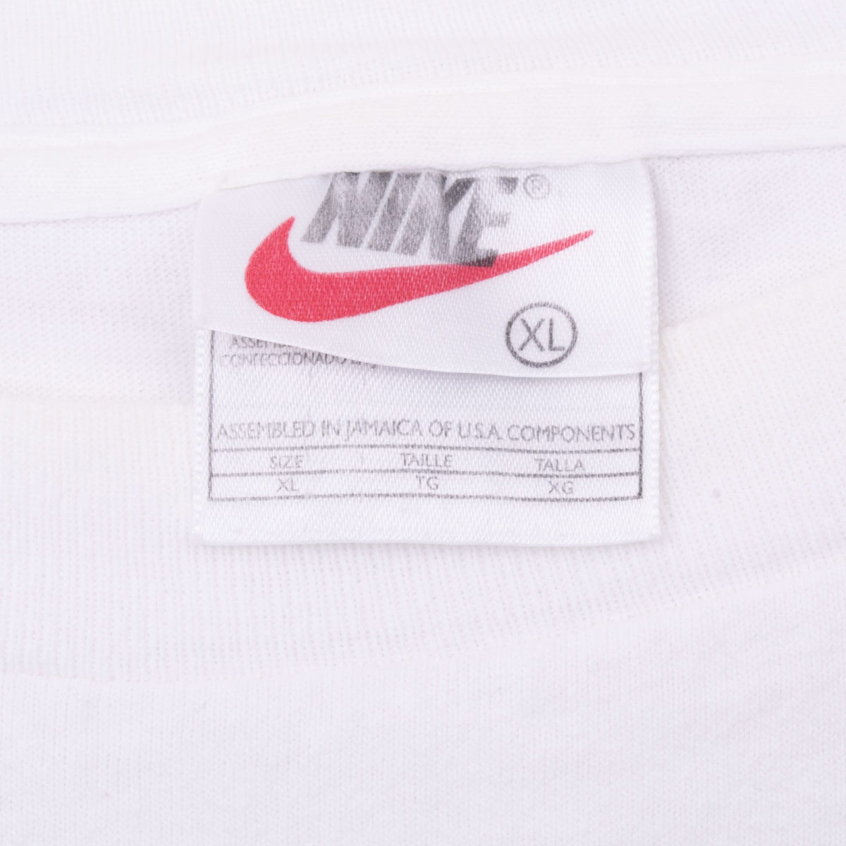 Nike neck tag detail showing XL sizing on white T-shirt