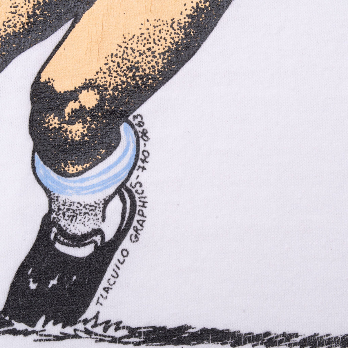 Close-up of Diego Maradona print showing leg, soccer cleat, and graphic artist signature