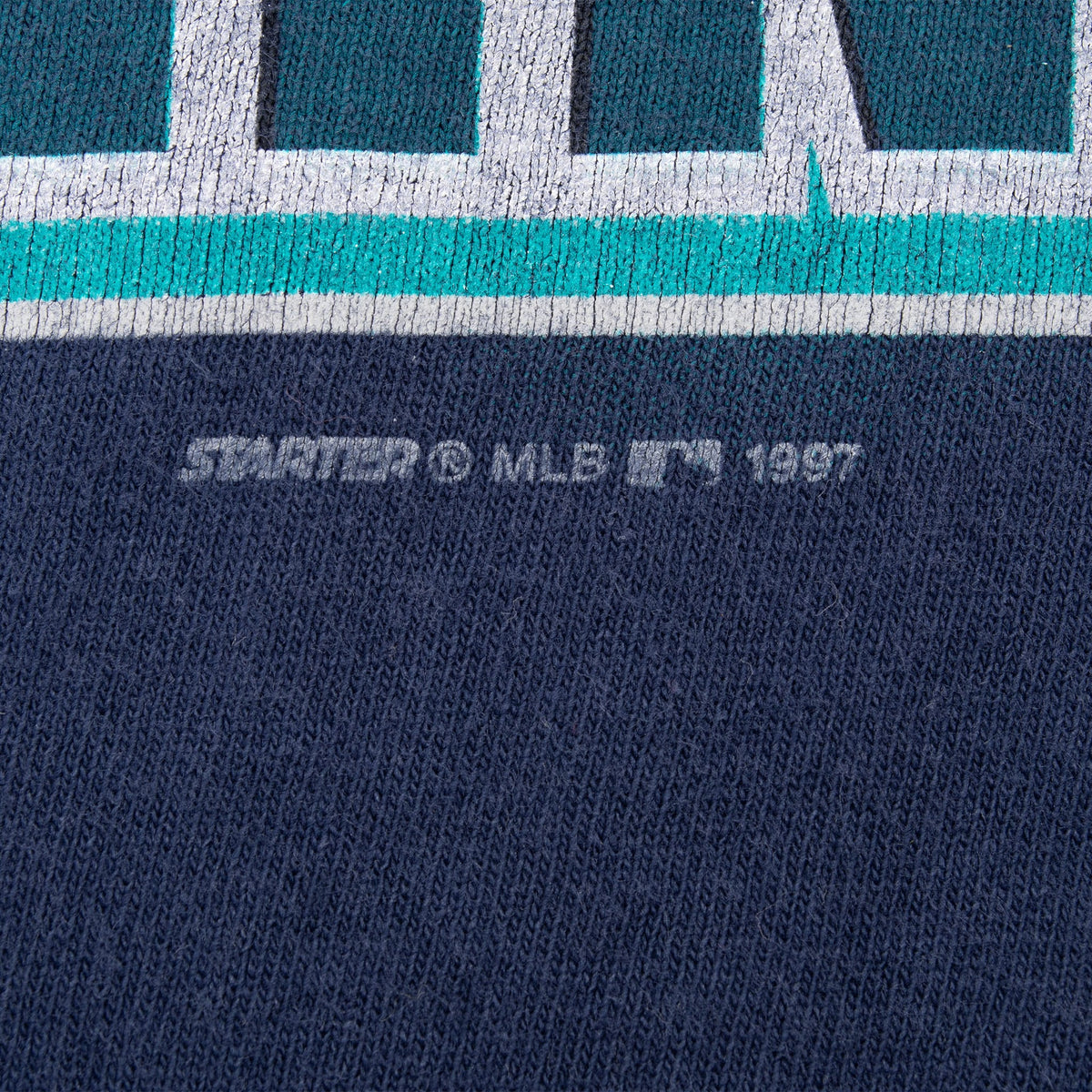 Close-up of Starter MLB 1997 copyright mark below the front print