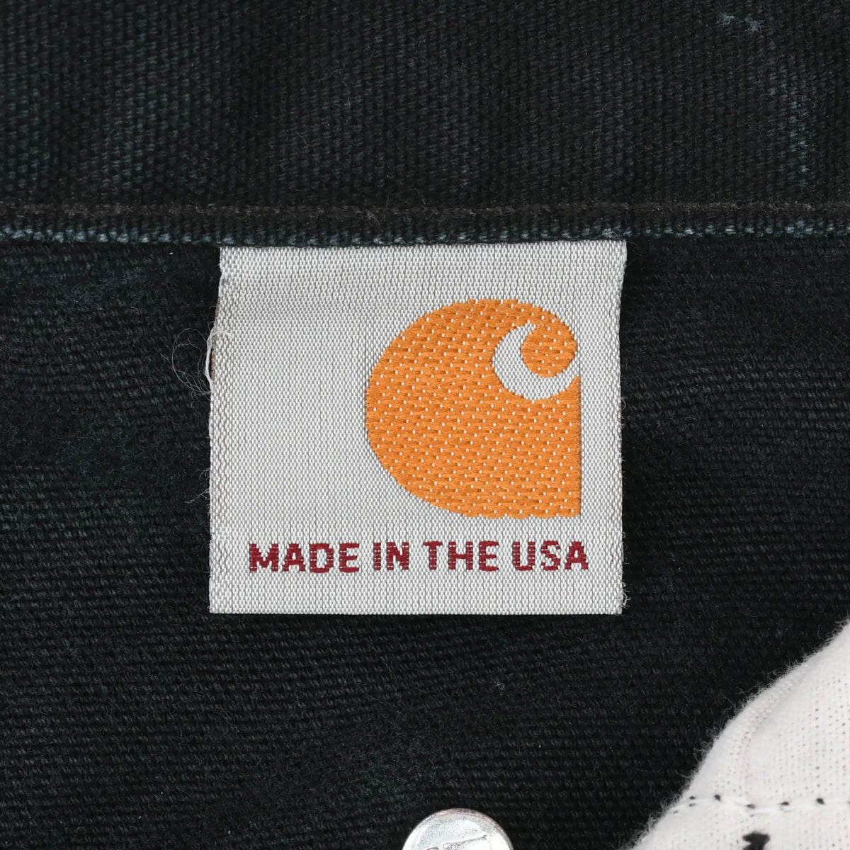 Interior Carhartt label with orange logo and Made in the USA text