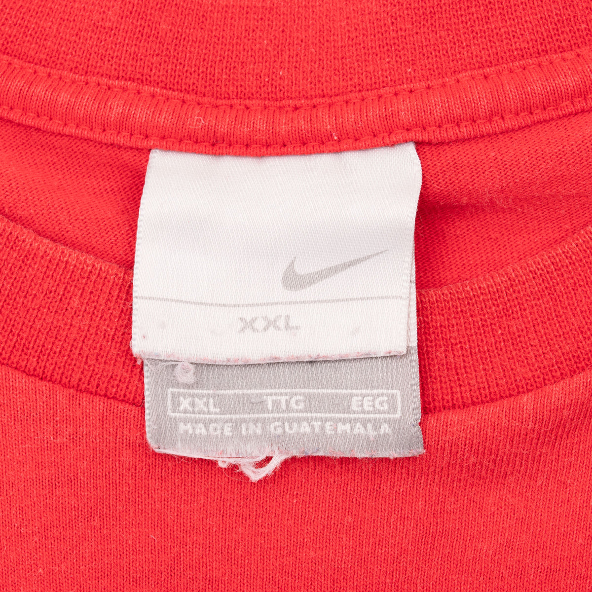 Nike neck tag marked XXL inside red T-shirt collar