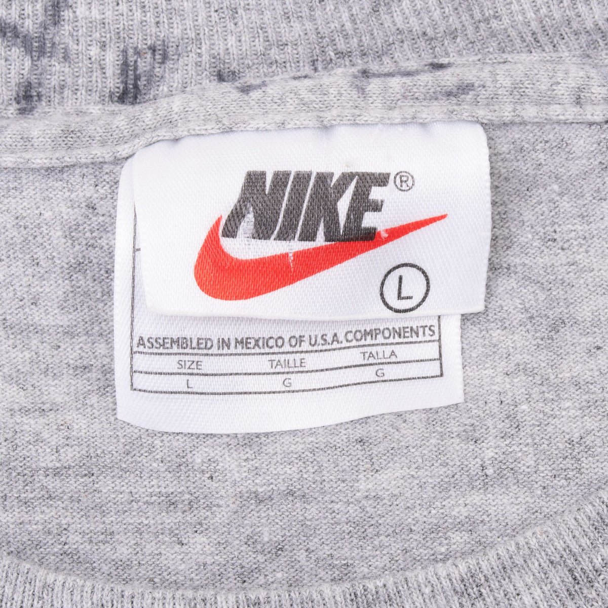 Nike neck label with Swoosh and size L marking on grey T-shirt