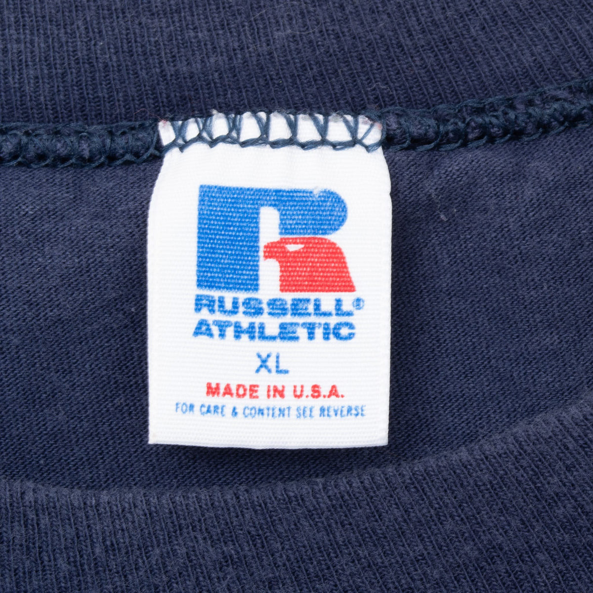 Russell Athletic neck tag marked XL and Made in U.S.A. inside navy T-shirt