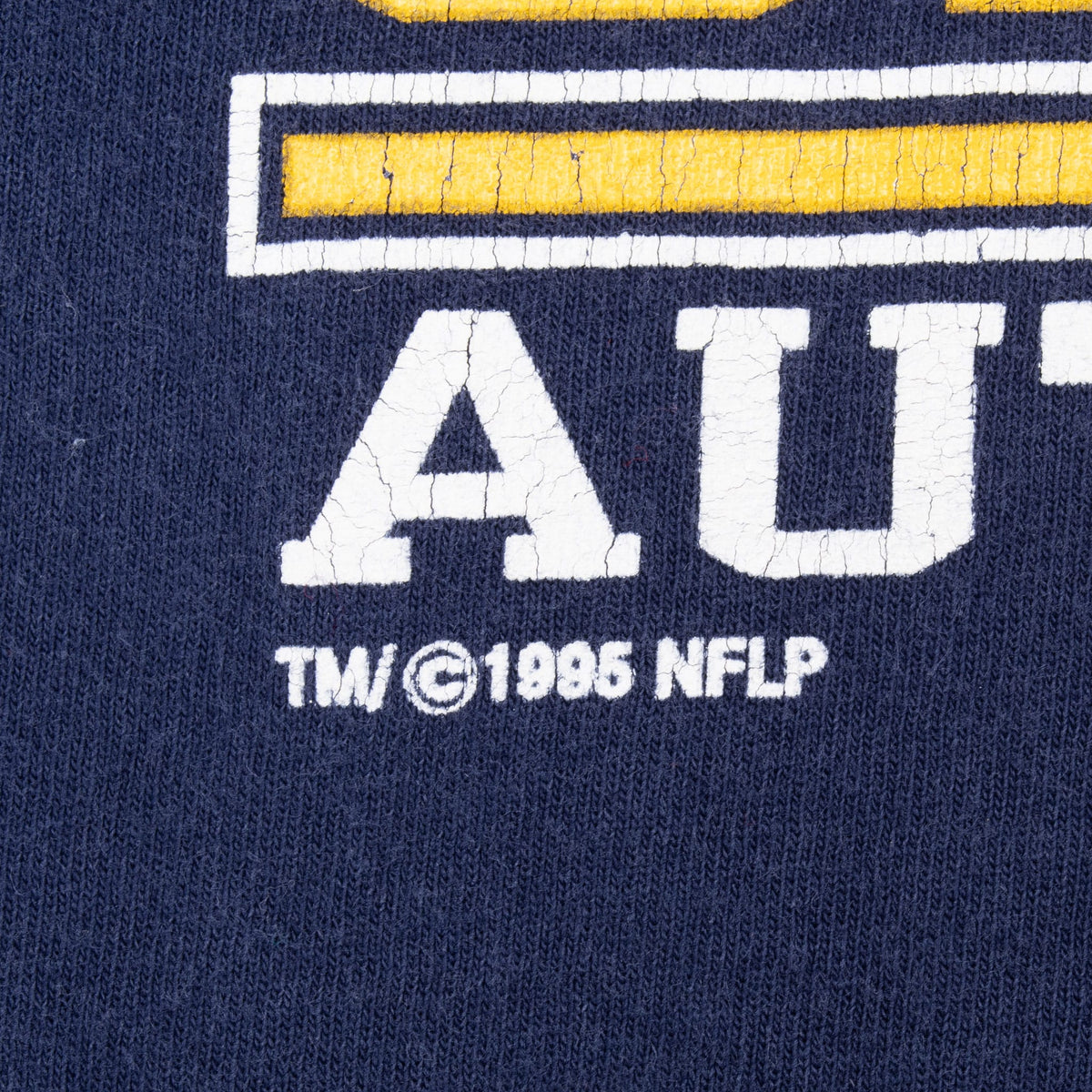 Close-up of cracked white front print with 1995 NFLP copyright mark
