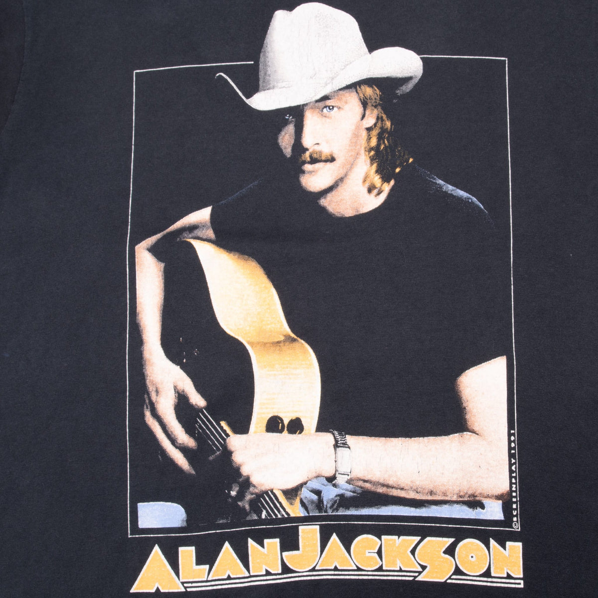 Close-up of Alan Jackson front graphic showing him in a cowboy hat holding a guitar