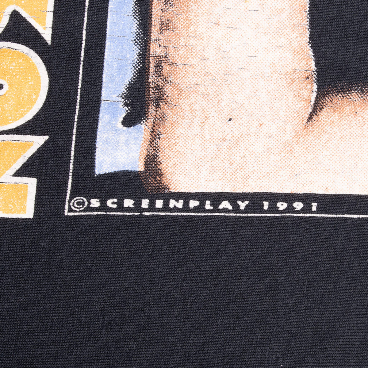 Close-up of Screenplay 1991 copyright text on the Alan Jackson front graphic