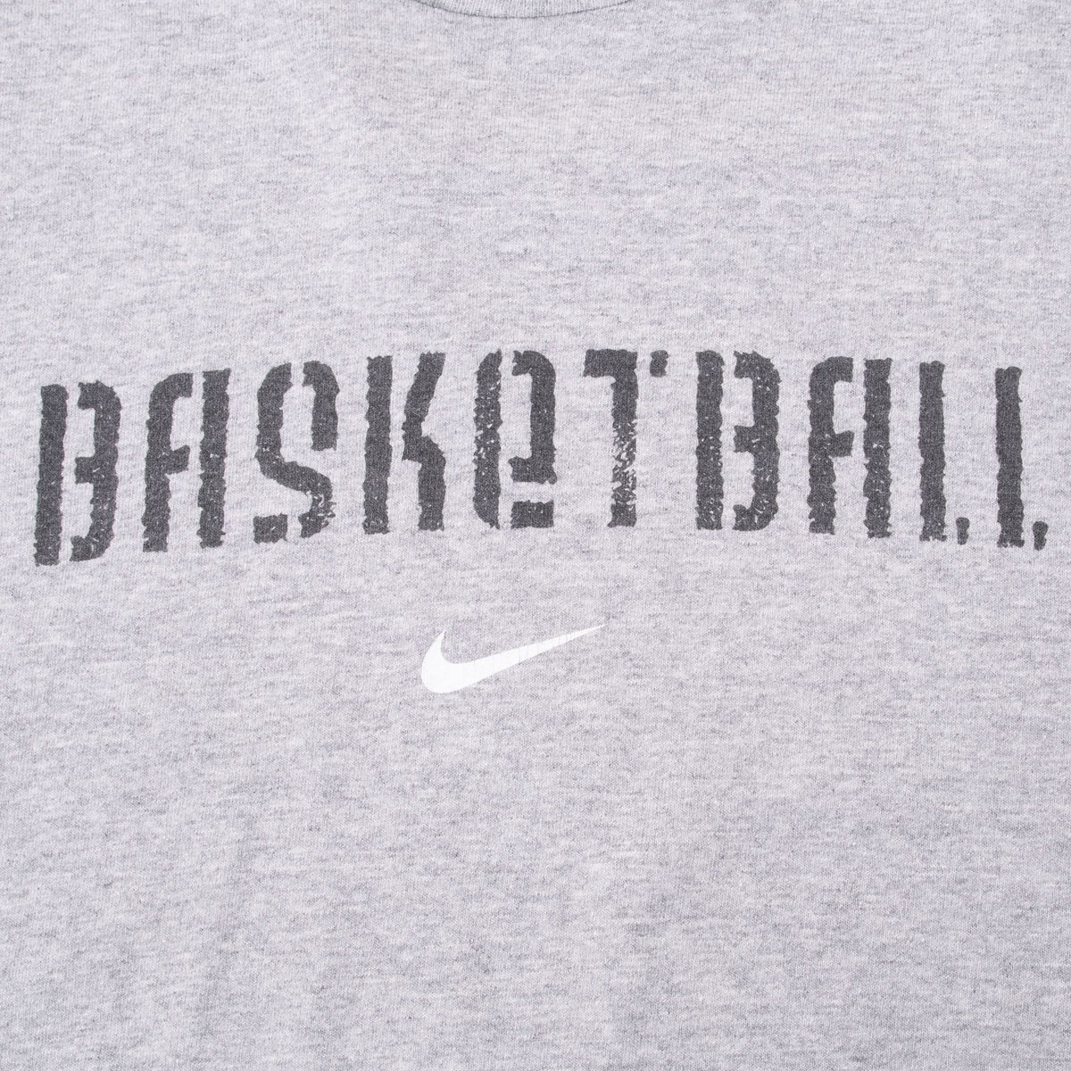 Close-up of dark Basketball chest print and white Nike Swoosh on grey fabric