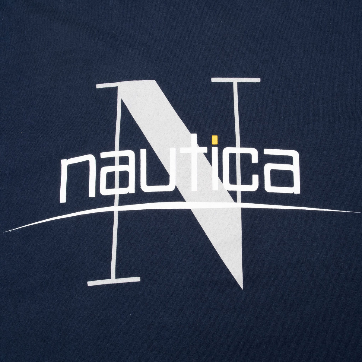 Close-up of white and gray Nautica N chest graphic with yellow accent