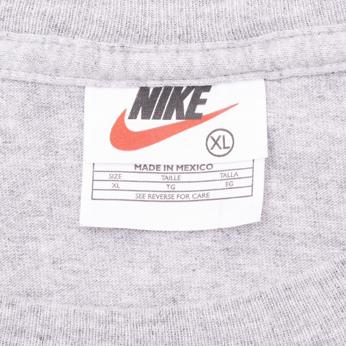 Nike neck tag marked XL and Made in Mexico on grey T-shirt