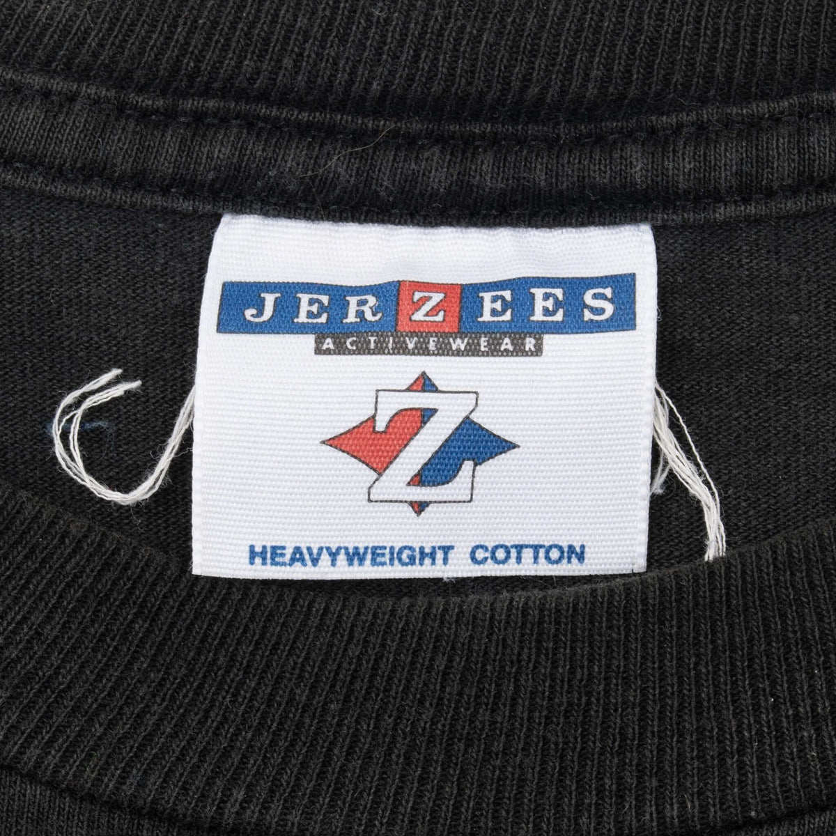 Close-up of Jerzees Activewear Heavyweight Cotton neck label on black T-shirt