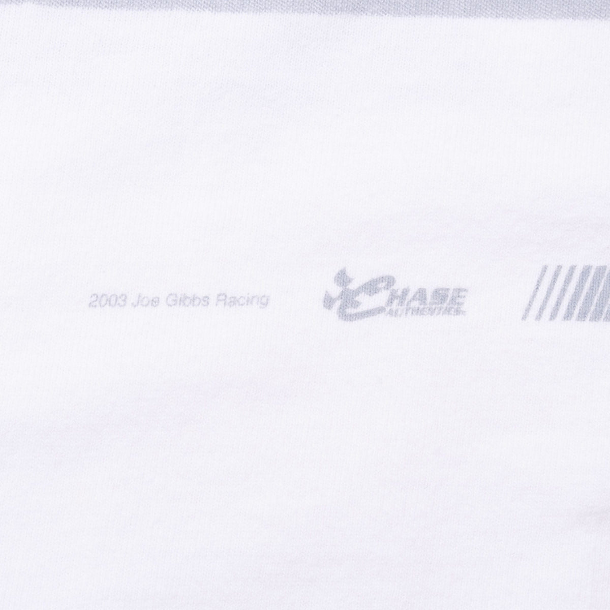 Faint 2003 Joe Gibbs Racing and Chase Authentics marks printed on white fabric