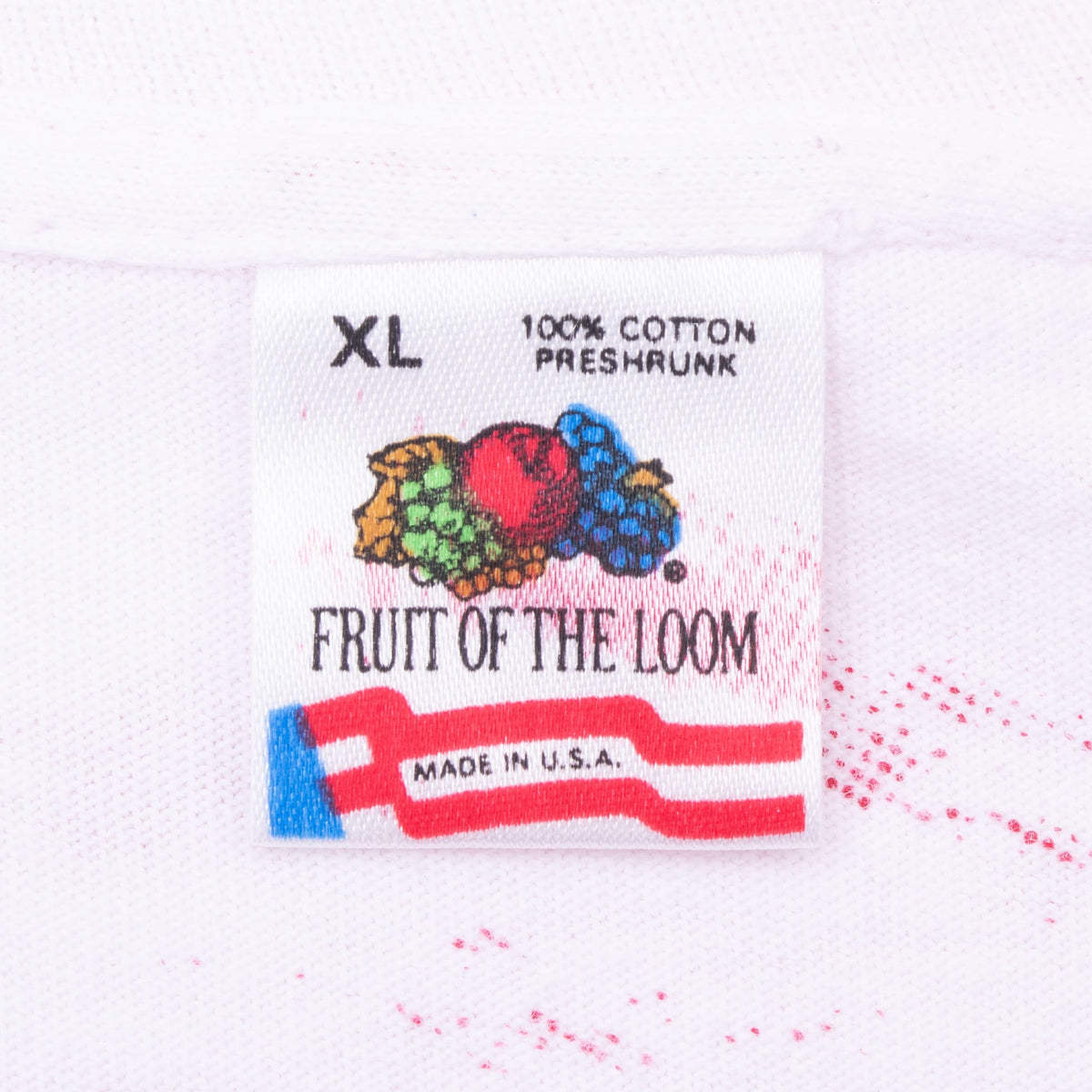 Fruit of the Loom XL neck tag showing 100% cotton, preshrunk and made in USA