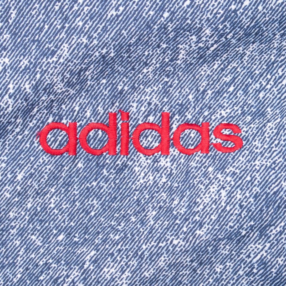 Red adidas logo embroidery on blue patterned chest