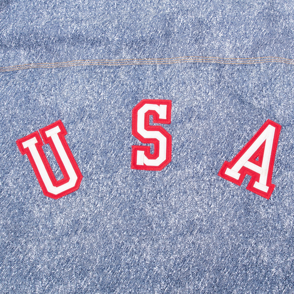 Close-up of red-and-white USA lettering across the jacket back