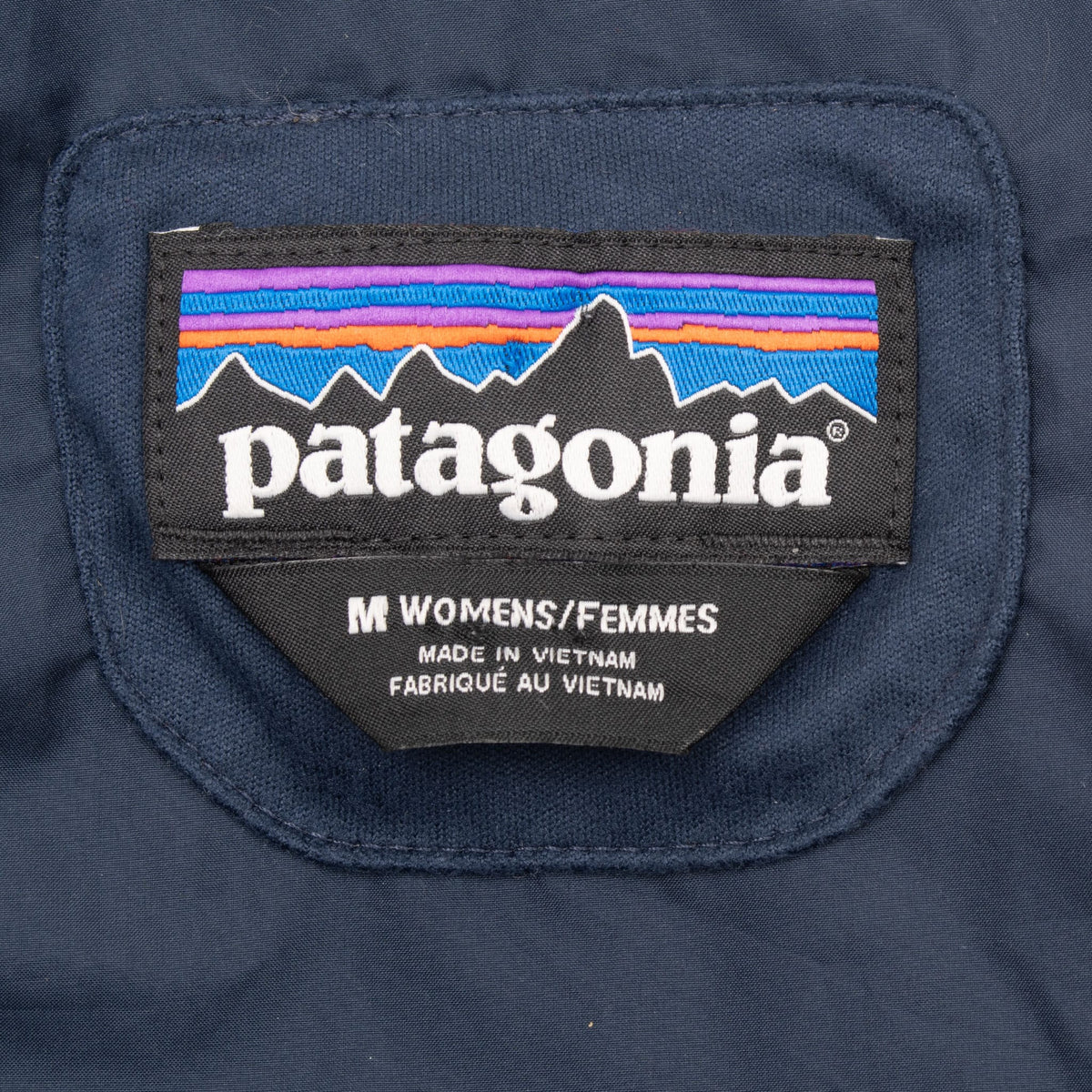 Patagonia neck label marked women's medium inside navy blue Radalie parka
