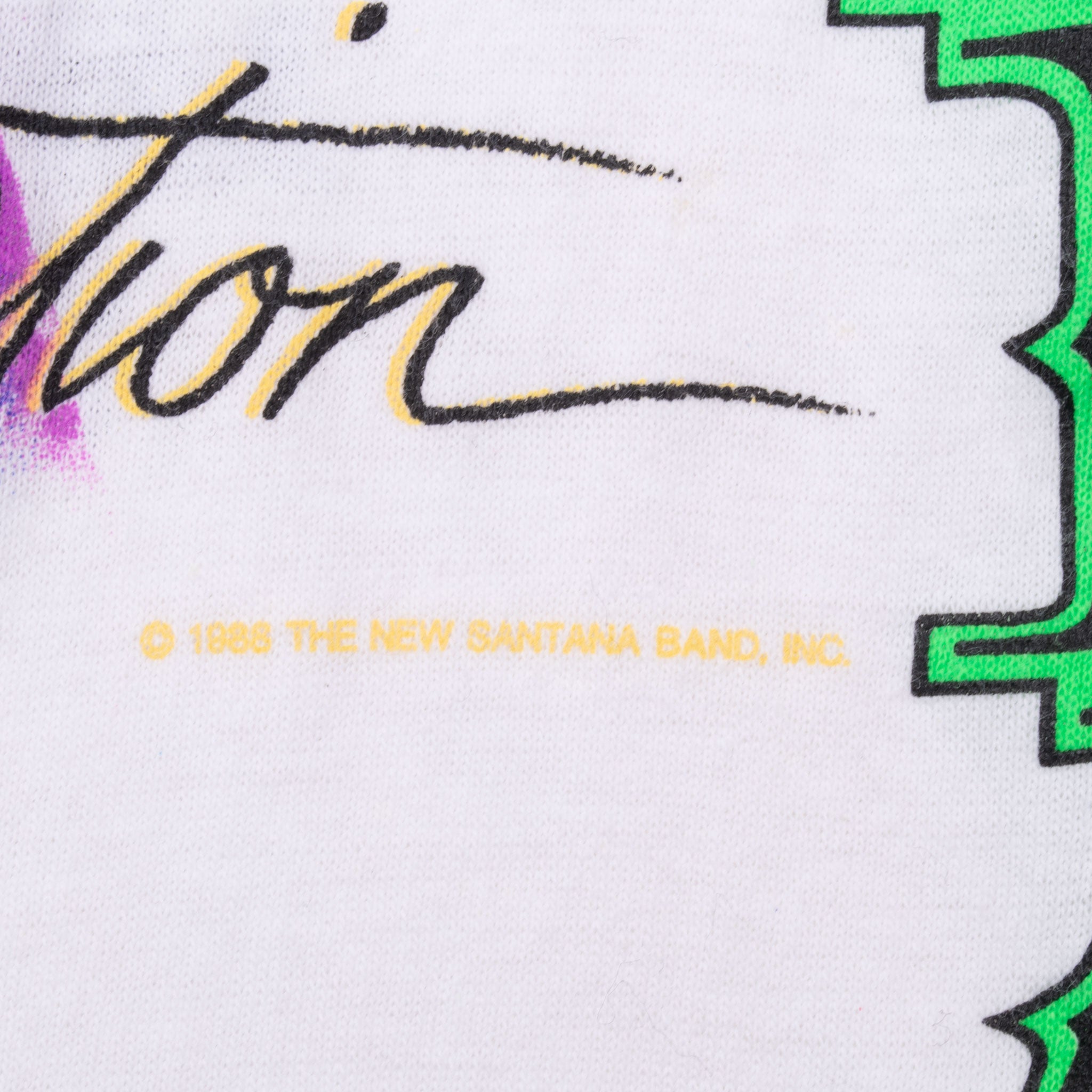 Close-up of front print showing 1988 The New Santana Band, Inc. copyright text