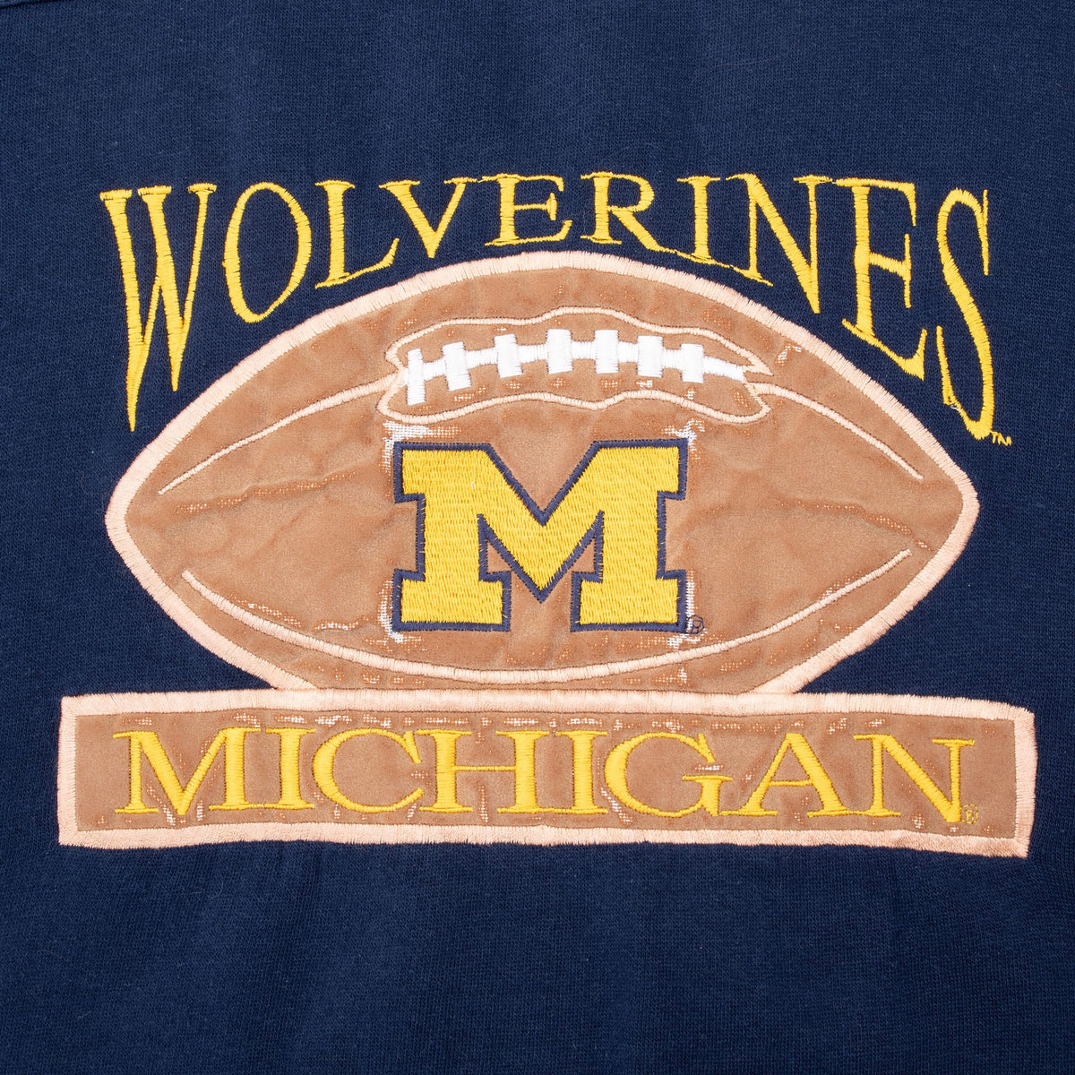 Close-up of Wolverines football and Michigan block M front graphic