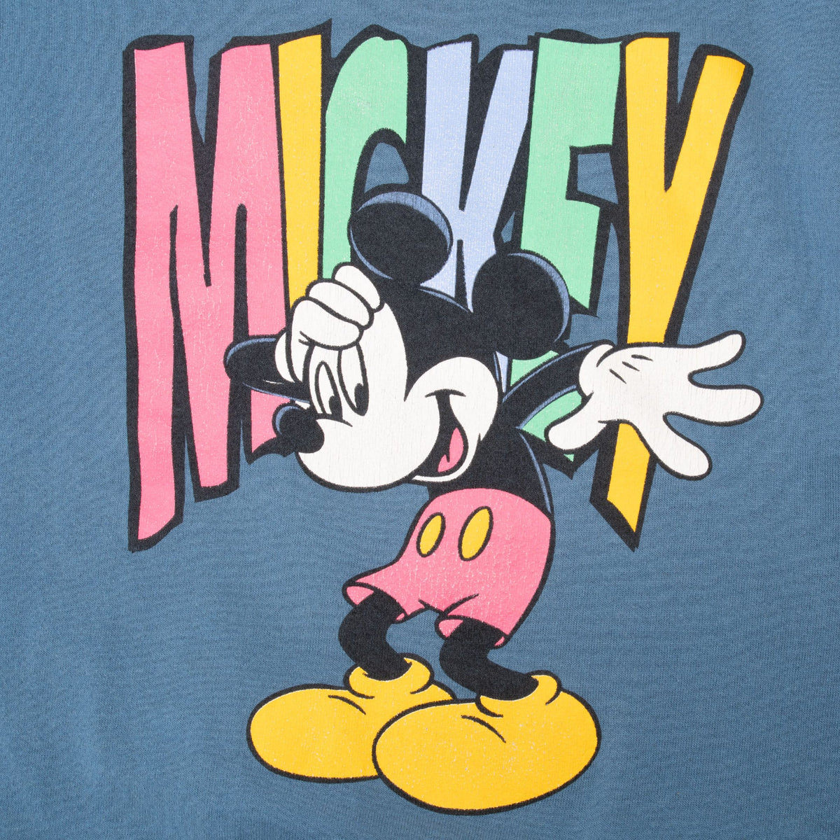 Close-up of Mickey Mouse graphic over multicolor block Mickey lettering