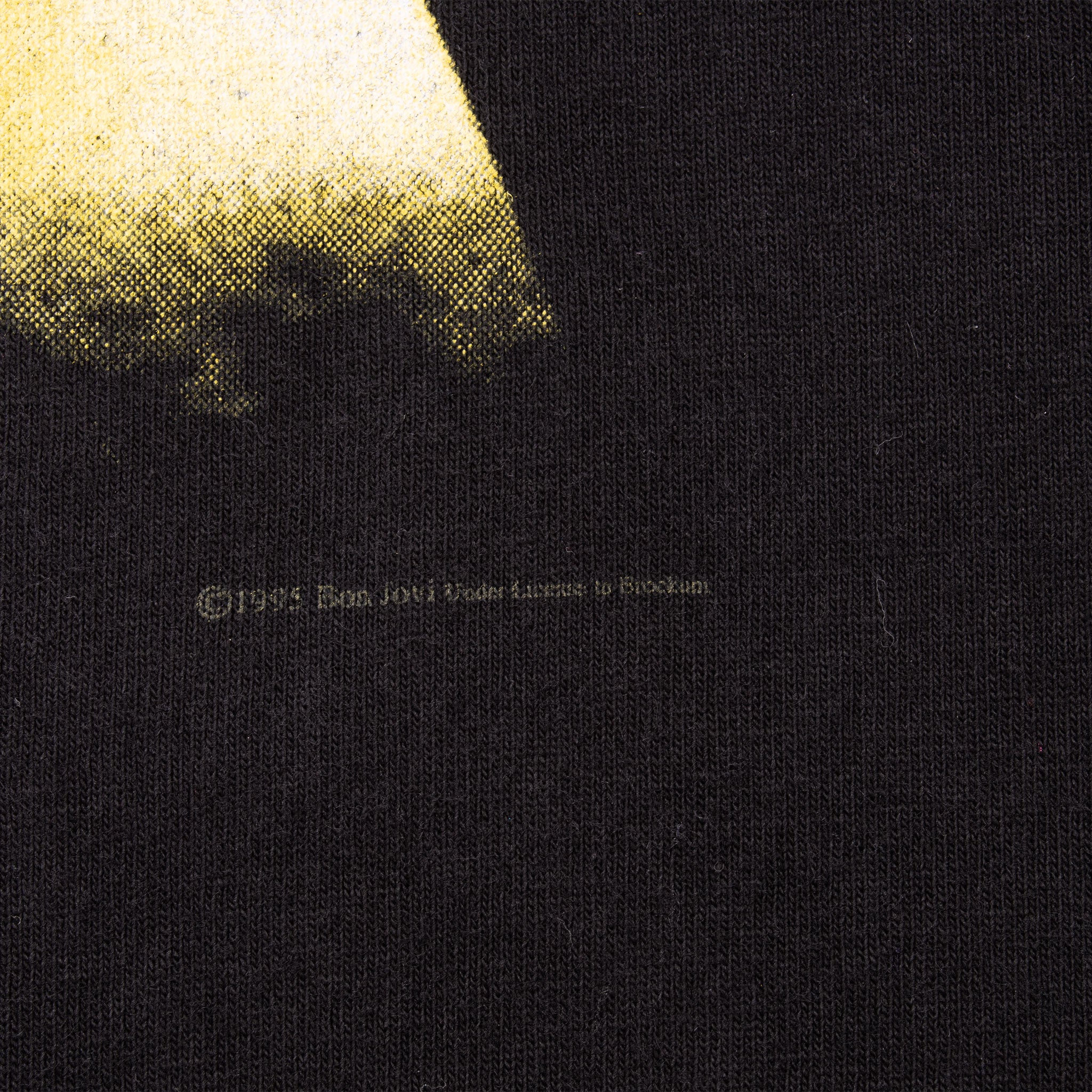 Close-up of small copyright and licensing text beneath the front print