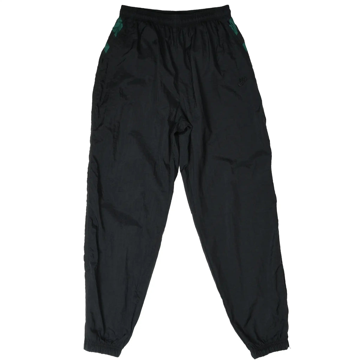 Front of black Nike track pants with green side accents, tonal Swoosh, and elastic cuffs