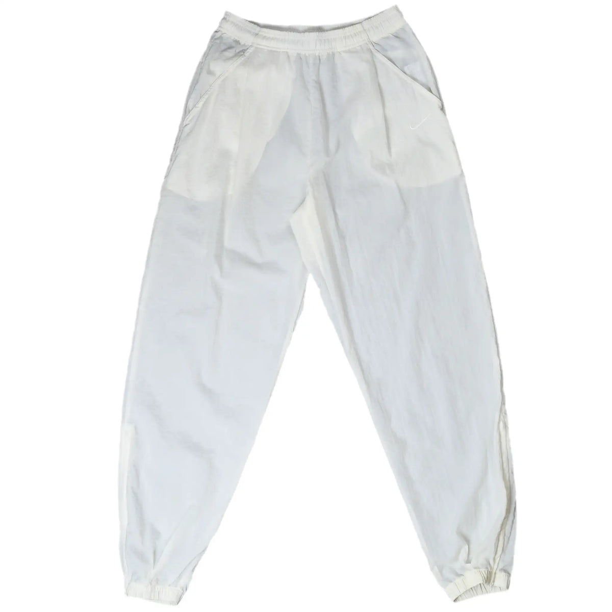 Front of white Nike track pants with side pockets, elastic cuffs, and tonal Swoosh embroidery