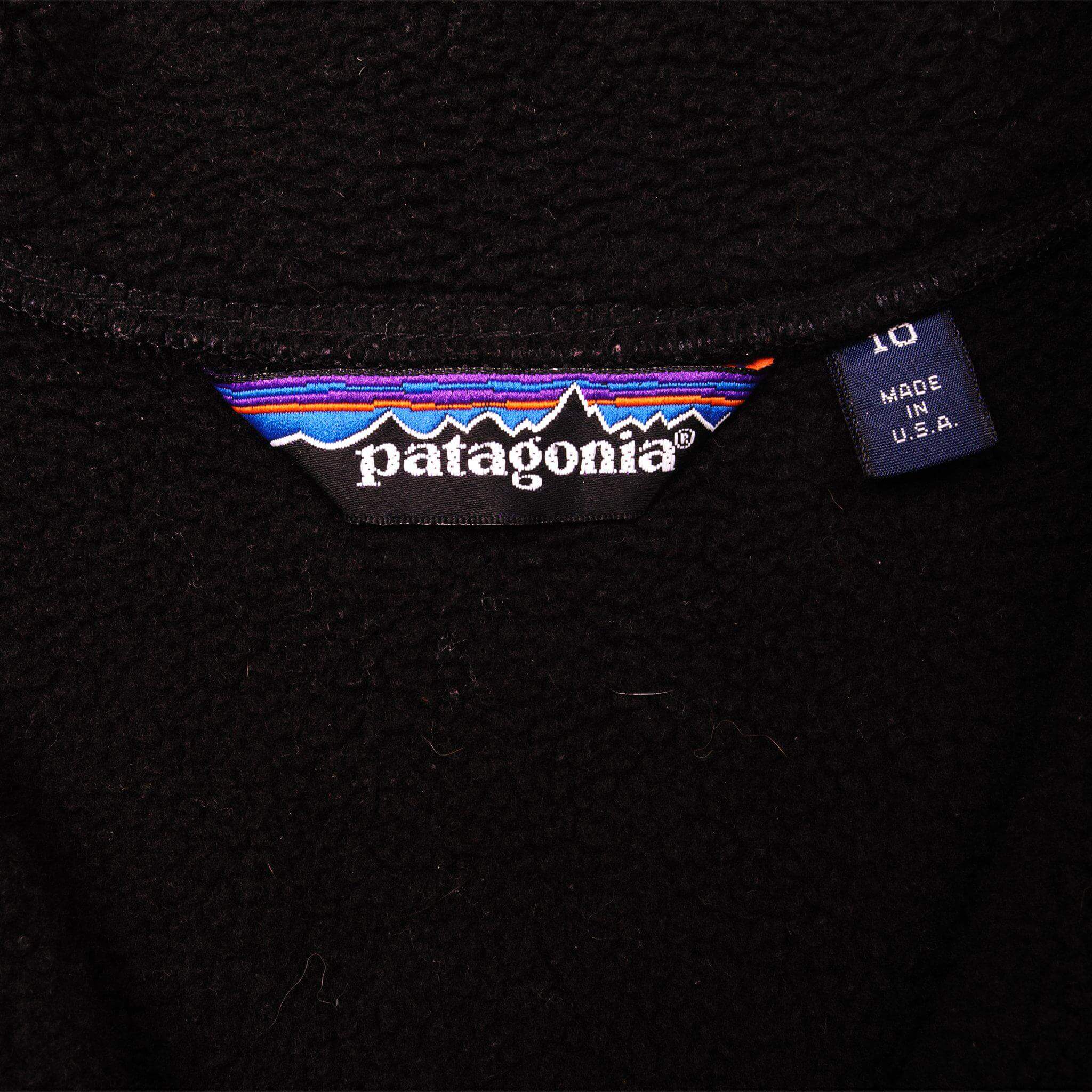 Patagonia neck label and Made in U.S.A. tag on black fleece