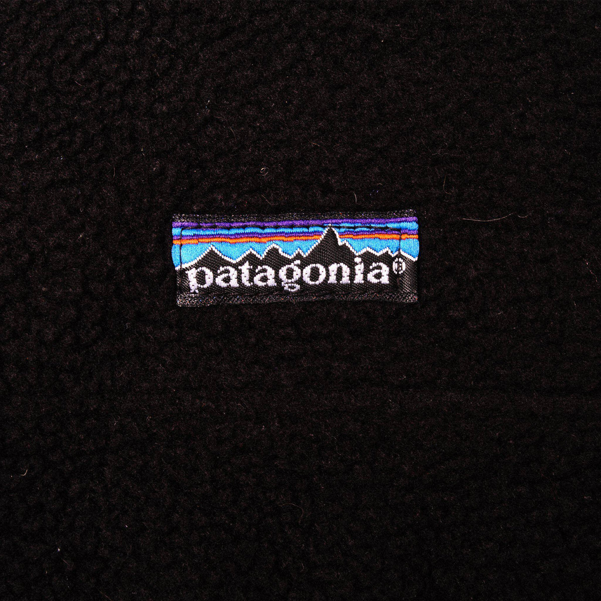 Patagonia mountain logo patch on black fleece chest