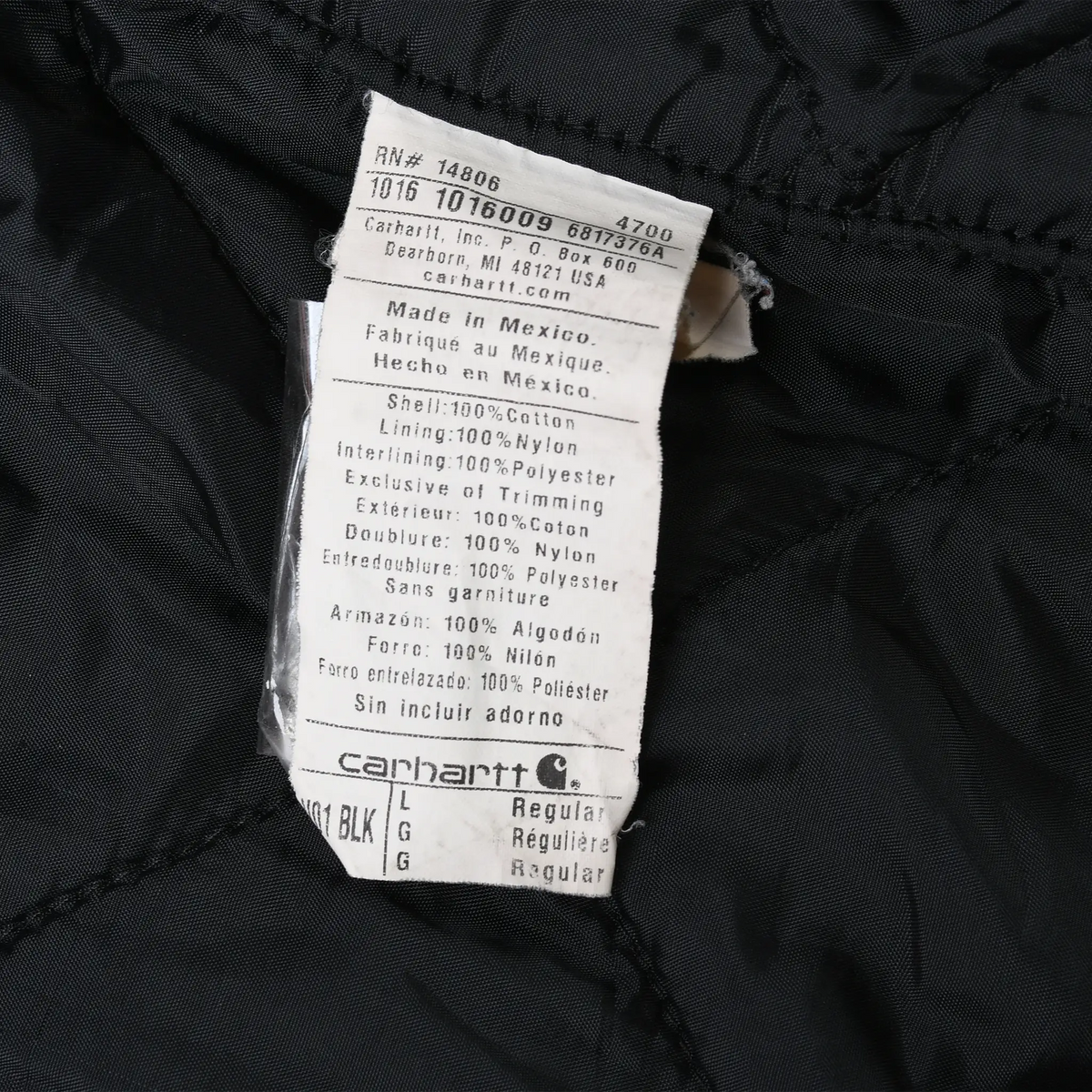 Close-up of care label inside Carhartt V01BLK vest with RN 14806 and fabric details