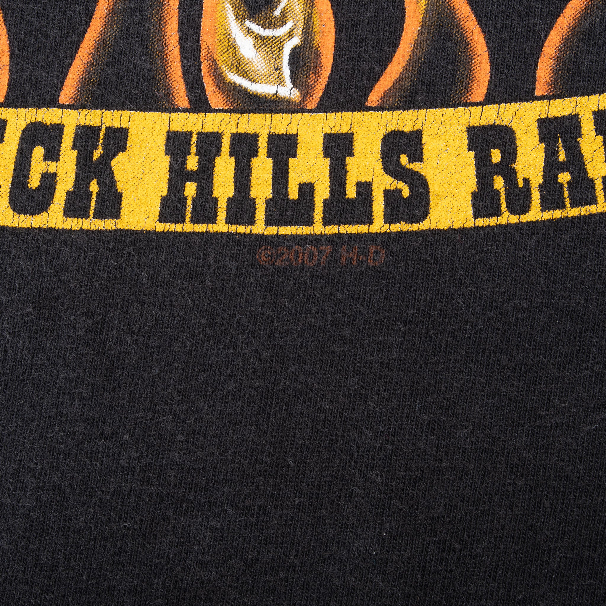 Close-up of yellow Black Hills Rally banner in the front graphic on black fabric