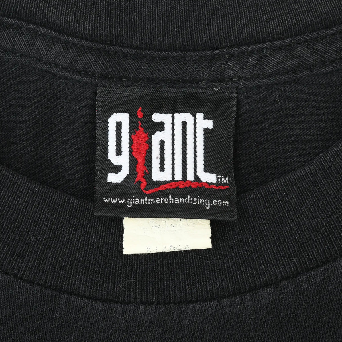 Close-up of Giant Merchandising neck label on black T-shirt