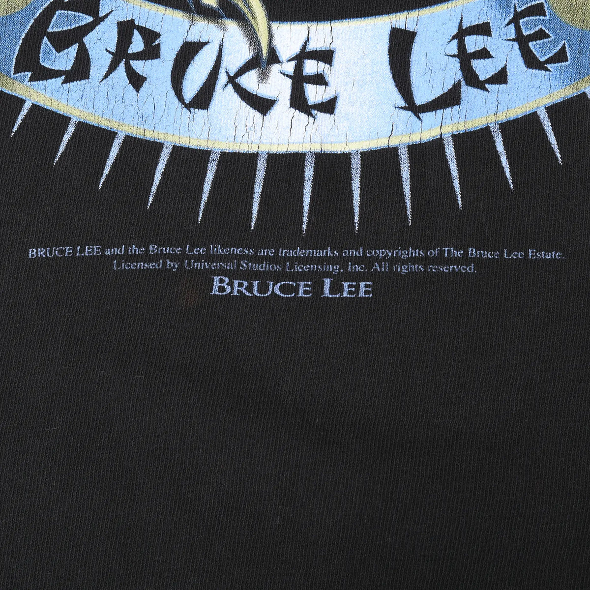 Close-up of Bruce Lee name banner and licensing text beneath the front graphic