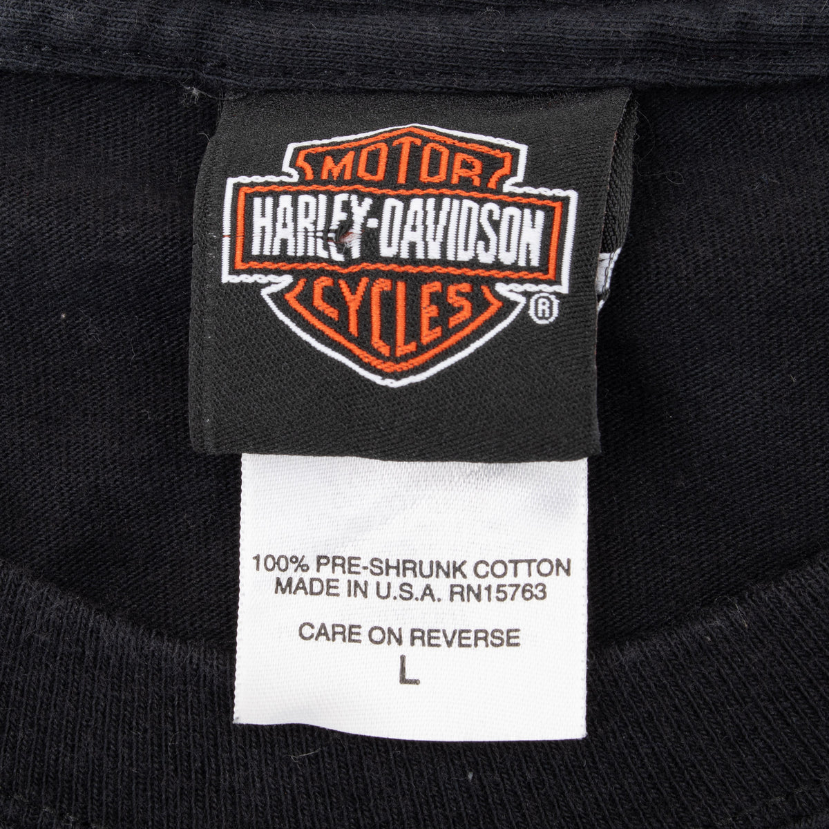 Harley-Davidson neck and care tags marked large, 100% pre-shrunk cotton, and made in USA