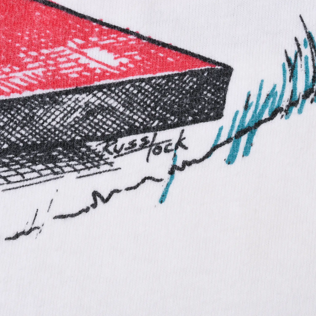 Close-up of Russ Tock signature beside red platform and teal grass detail