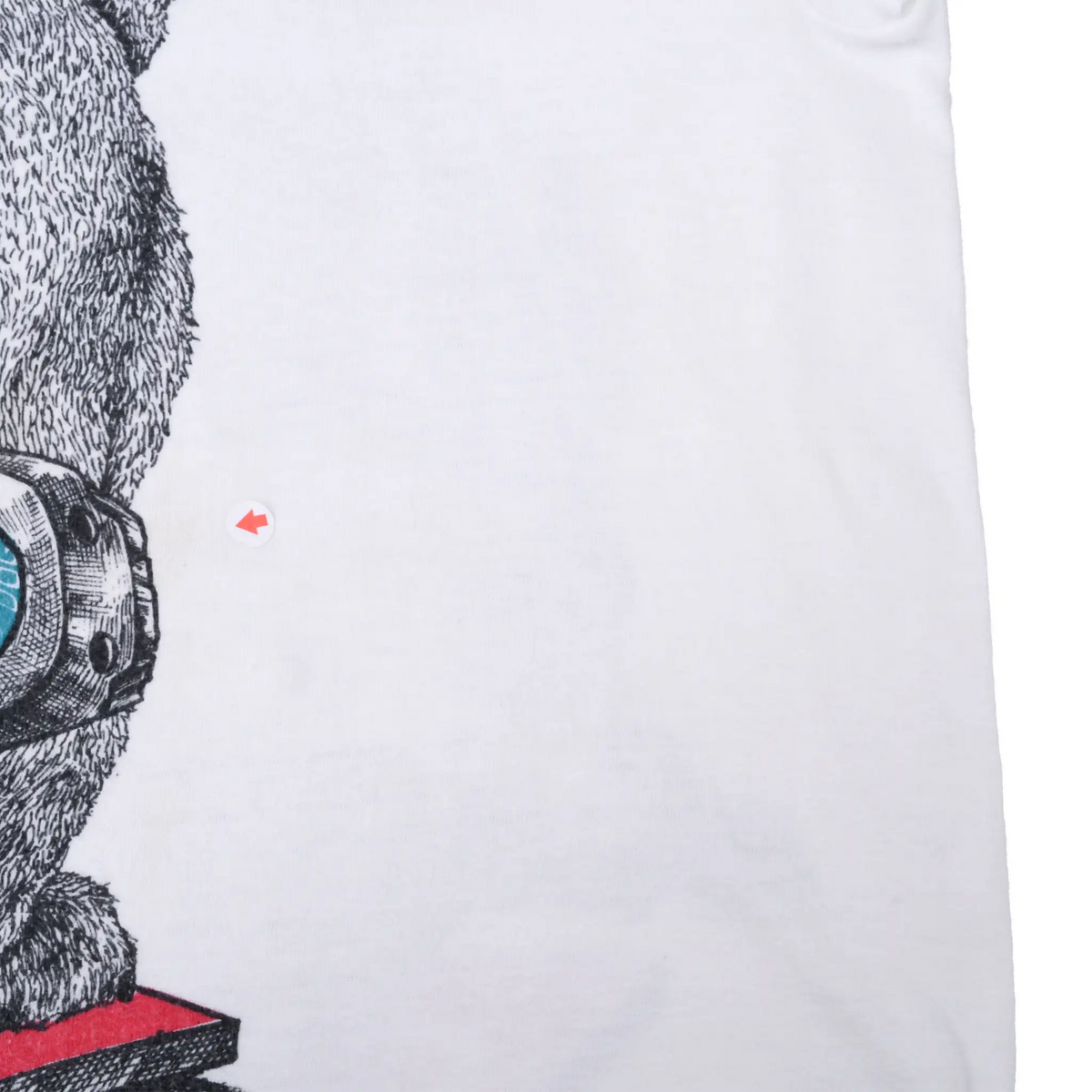 Close-up of white shirt area beside back graphic with arrow marking a small spot