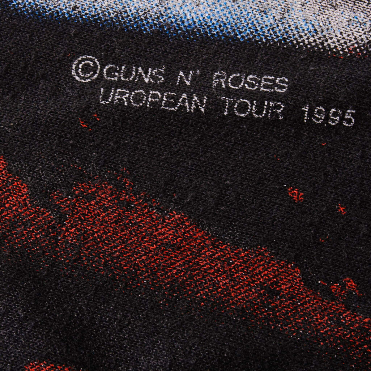 Print detail reading © Guns N' Roses European Tour 1995 on black fabric