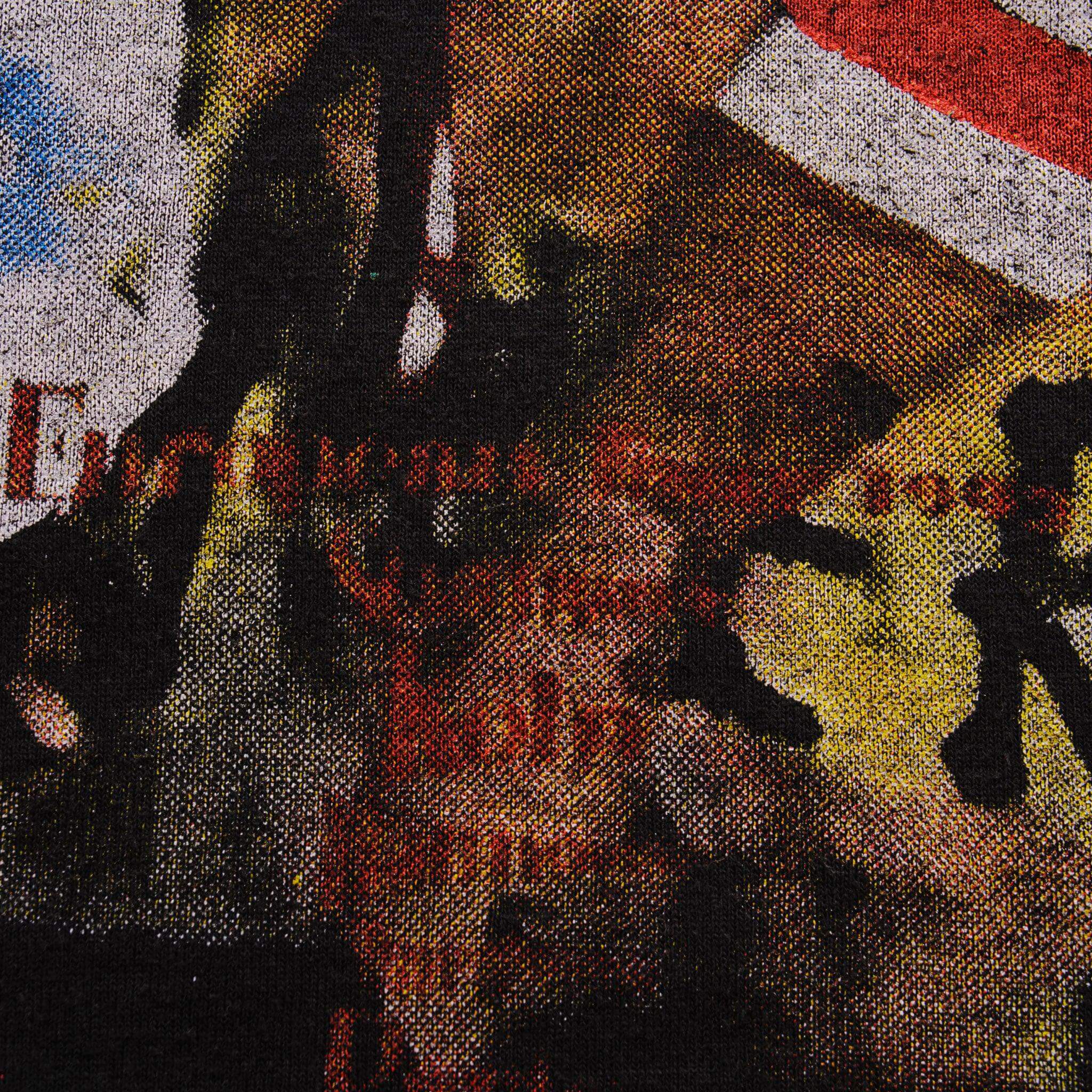 Close-up of red lettering and concert crowd imagery on the back print